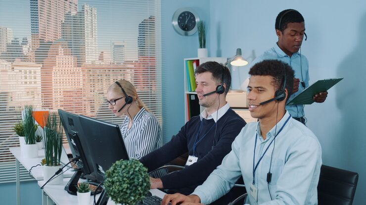 multiethnic-customer-service-representative-telling-his-colleagues-joke-while-calling-clients_178151-992